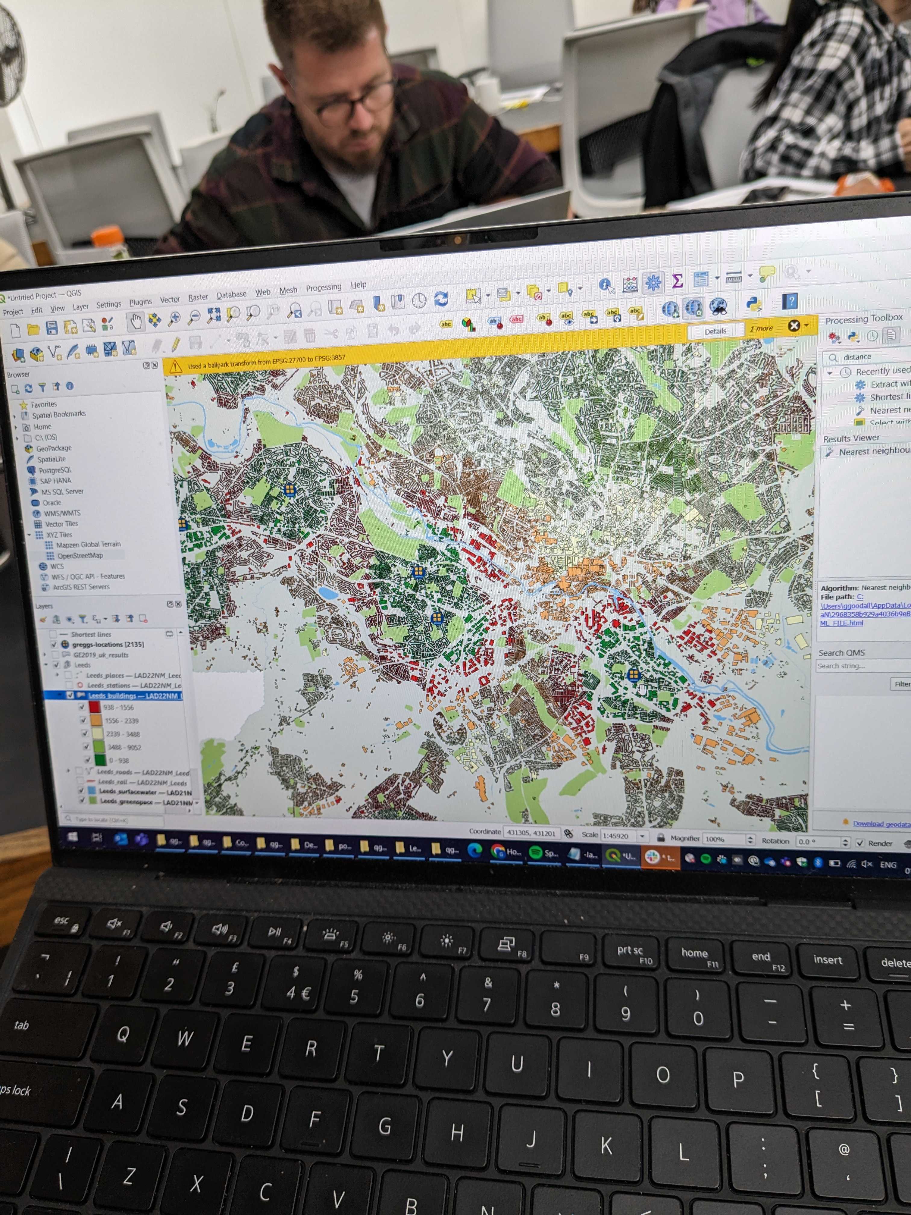 Laptop screen showing a QGIS map